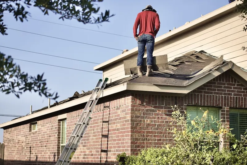 Professional roofer working on a residential roof in Krauss